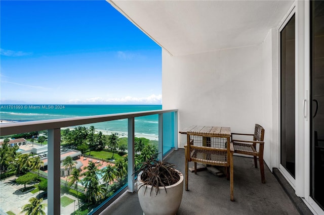 balcony with a water view and a beach view