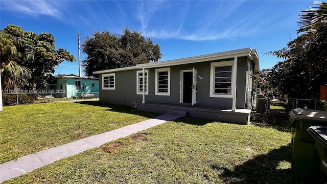 bungalow-style home featuring a front yard