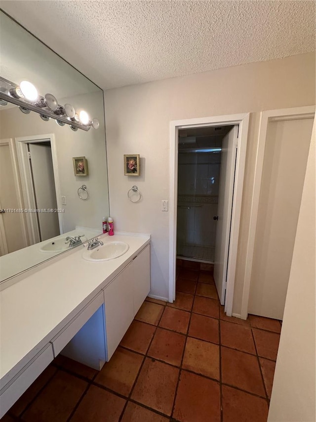 bathroom featuring tile patterned floors, vanity, and a textured ceiling