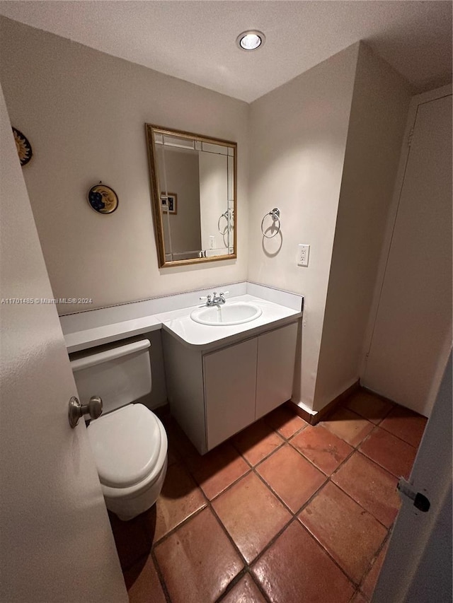 bathroom with tile patterned floors, vanity, and toilet