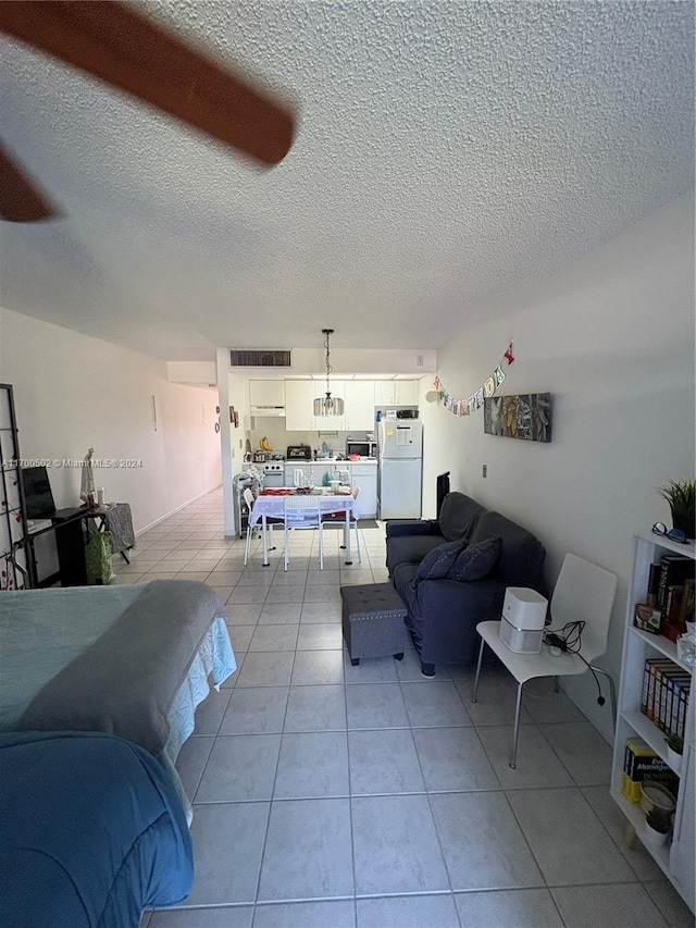 living room featuring light tile patterned floors and a textured ceiling