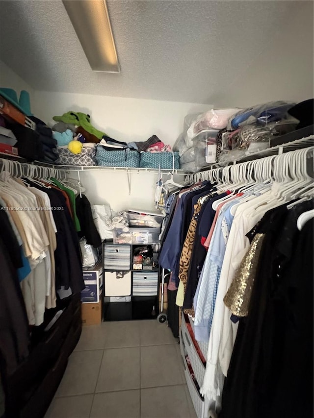 spacious closet with light tile patterned floors