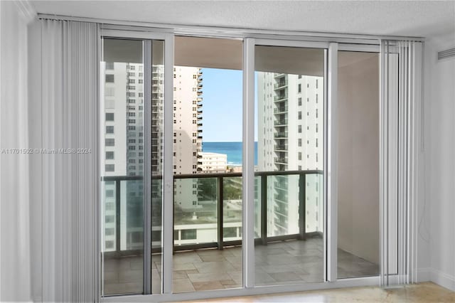 entryway featuring expansive windows and a water view