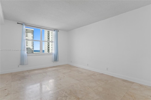 empty room featuring a textured ceiling