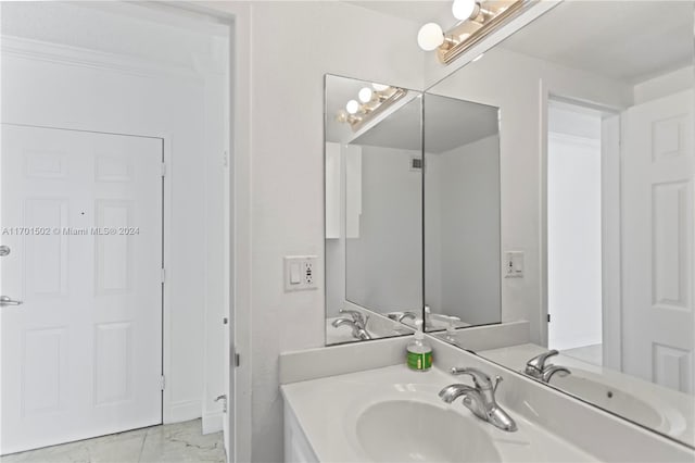 bathroom with crown molding and vanity