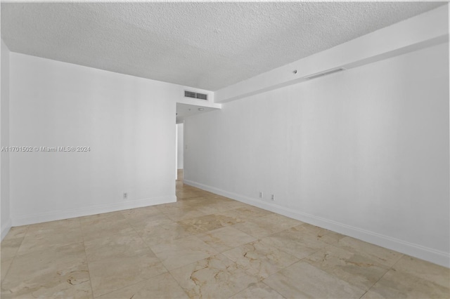 empty room featuring a textured ceiling