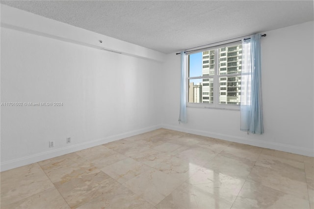 spare room featuring a textured ceiling