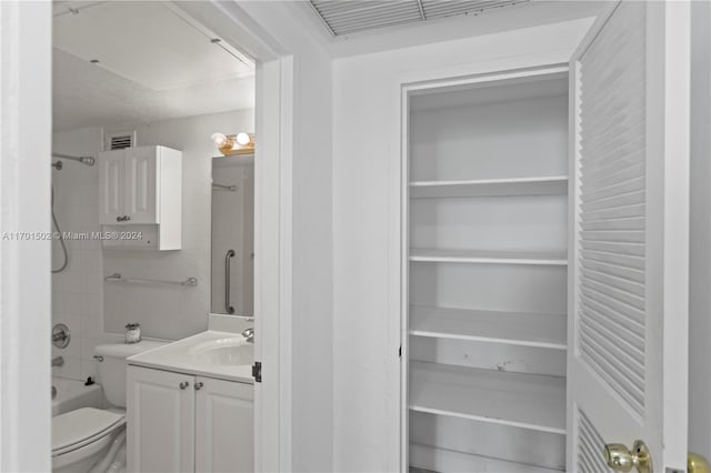 full bathroom featuring vanity, toilet, and tiled shower / bath combo