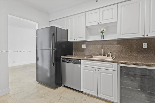 kitchen with sink, beverage cooler, stainless steel appliances, white cabinets, and ornamental molding