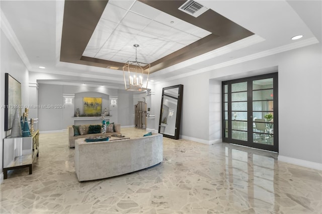 living room featuring a tray ceiling, crown molding, and french doors