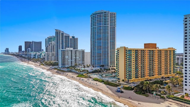 exterior space with a water view and a view of the beach