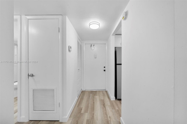 corridor with light hardwood / wood-style flooring