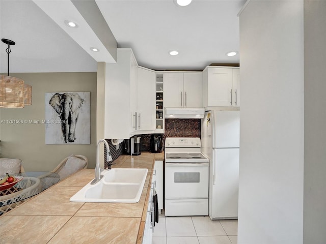 kitchen with white appliances, sink, white cabinetry, hanging light fixtures, and light tile patterned flooring