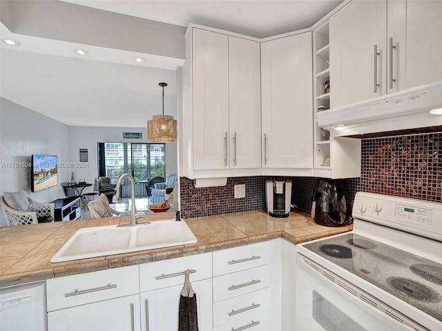 kitchen featuring sink, backsplash, decorative light fixtures, white appliances, and white cabinets