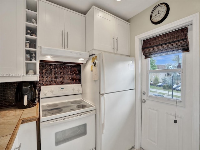 kitchen with white appliances, tile countertops, and white cabinetry