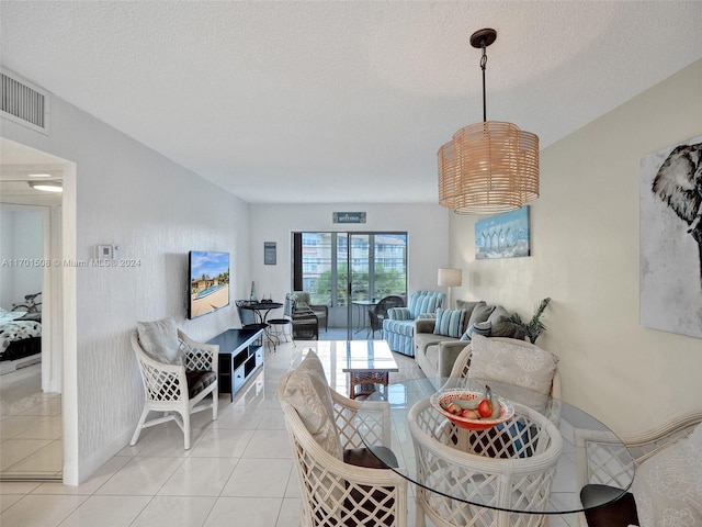 tiled dining area with a textured ceiling