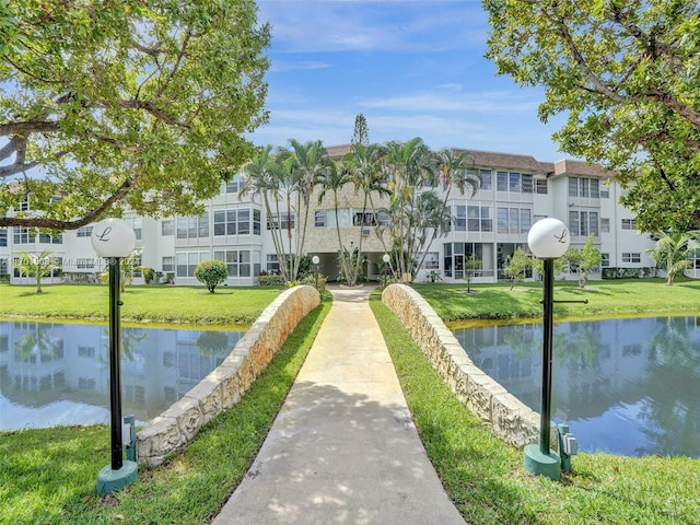 view of community featuring a yard and a water view