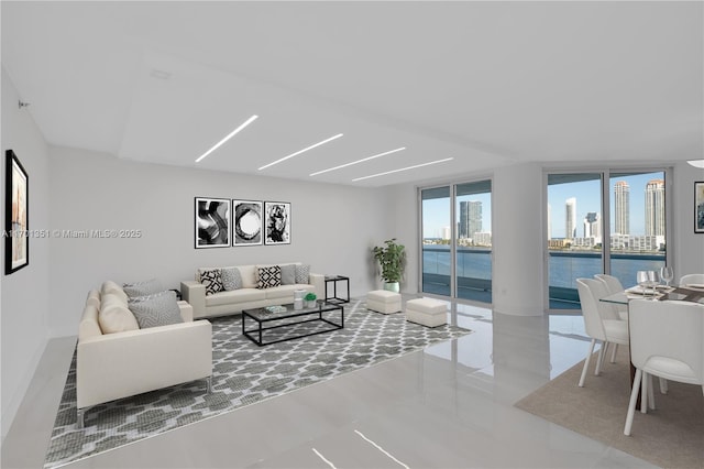 living room featuring expansive windows and a water view