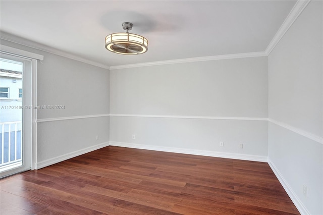 unfurnished room with dark hardwood / wood-style flooring and ornamental molding