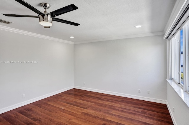 unfurnished room with a textured ceiling, dark hardwood / wood-style floors, and crown molding