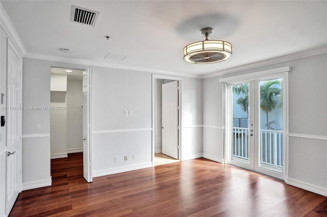 unfurnished room featuring french doors, dark hardwood / wood-style floors, and ornamental molding