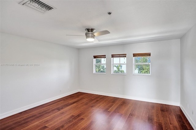 unfurnished room with ceiling fan and dark hardwood / wood-style flooring