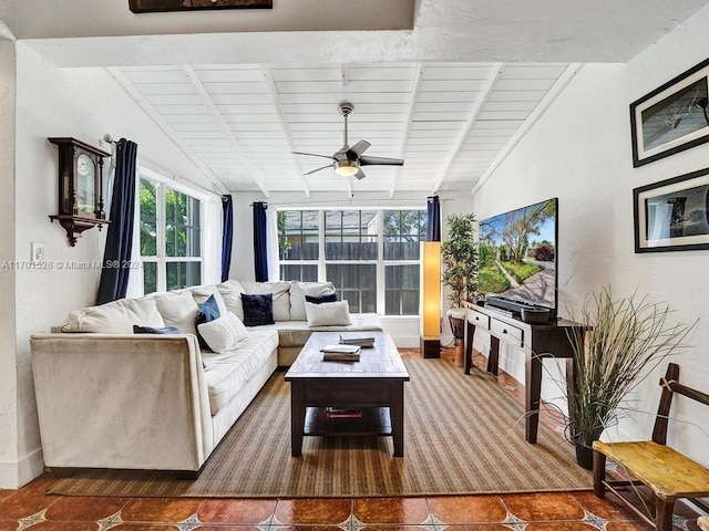 tiled living room with ceiling fan, lofted ceiling with beams, and wooden ceiling