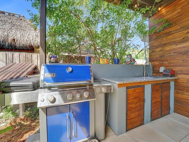 view of patio / terrace with a grill, area for grilling, and sink