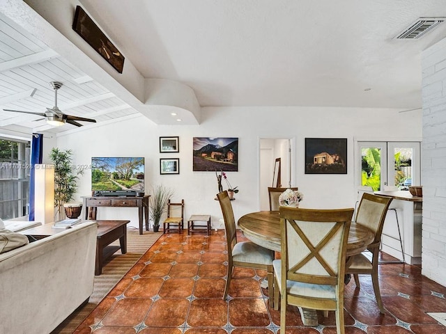 tiled dining space featuring lofted ceiling with beams, ceiling fan, and french doors