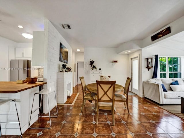 dining room featuring dark tile patterned flooring