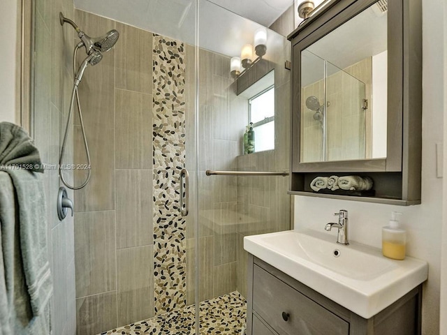 bathroom featuring vanity and a shower with shower door