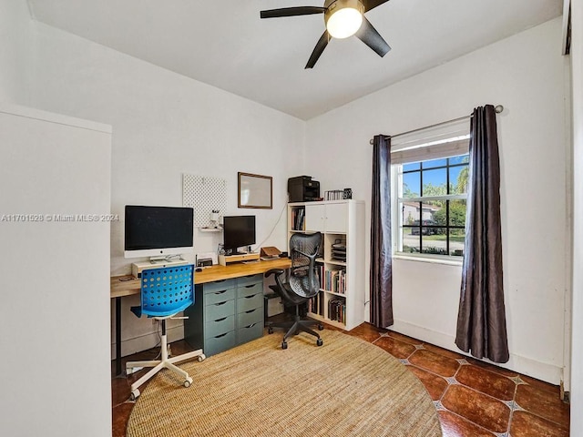 office with ceiling fan and dark tile patterned floors