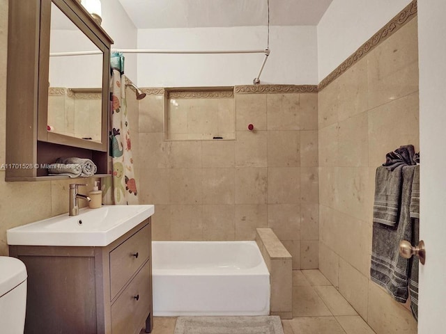 full bathroom with vanity, shower / bath combo, tile patterned flooring, toilet, and tile walls