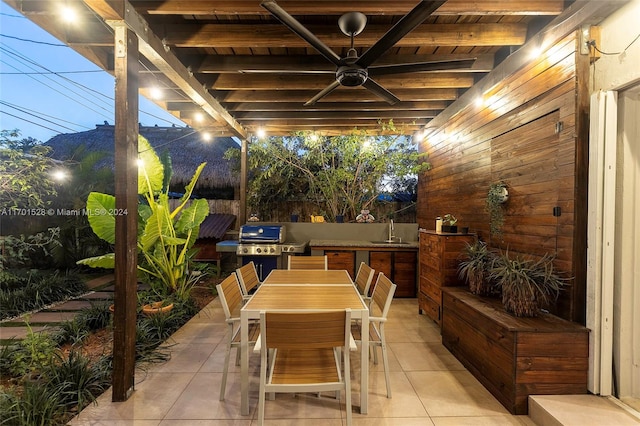 view of patio featuring ceiling fan, an outdoor kitchen, grilling area, and sink