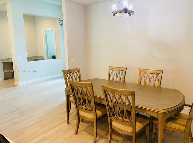 dining area featuring a chandelier and light hardwood / wood-style floors