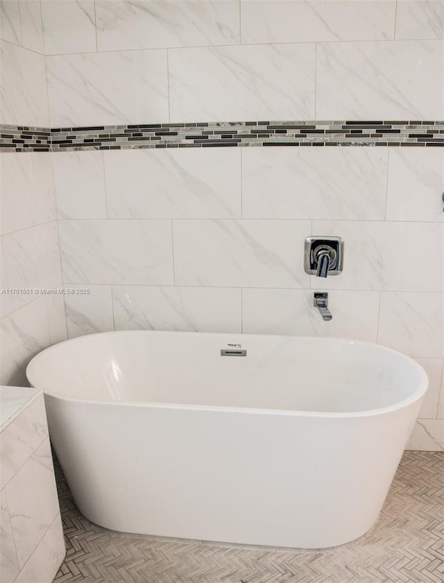 5231 NW Iredell St, Port St Lucie, FL 34986 - full bath featuring a freestanding bath and tile walls