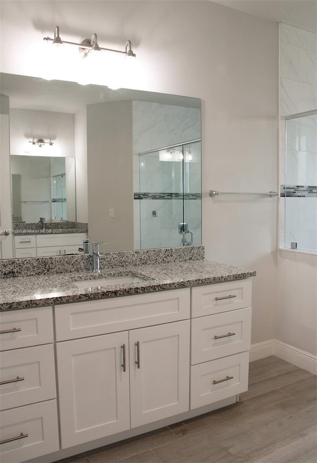 5231 NW Iredell St, Port St Lucie, FL 34986 - full bath featuring tiled shower, wood finished floors, vanity, and baseboards
