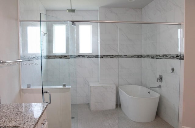 5231 NW Iredell St, Port St Lucie, FL 34986 - full bath with a shower stall, a freestanding bath, vanity, and tile patterned floors