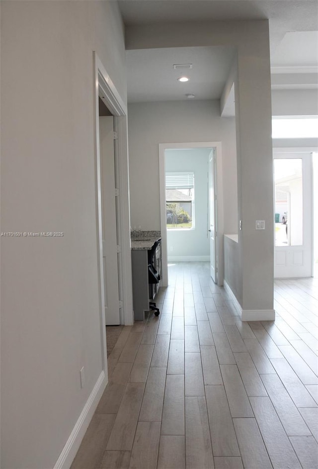 5231 NW Iredell St, Port St Lucie, FL 34986 - corridor featuring baseboards and light wood finished floors