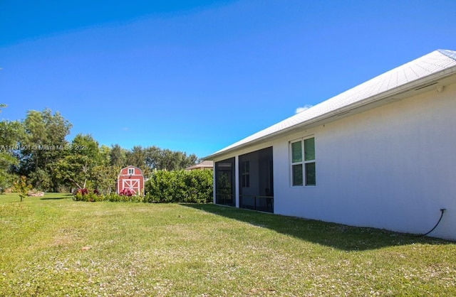 5231 NW Iredell St, Port St Lucie, FL 34986 - view of yard featuring a shed, an outdoor structure, and a sunroom