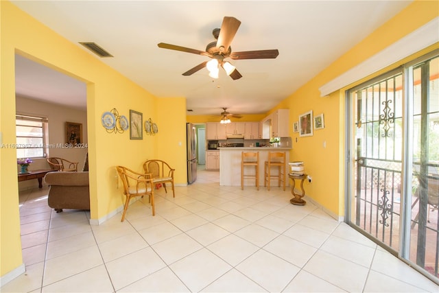 kitchen featuring stainless steel refrigerator, ceiling fan, and light tile patterned flooring