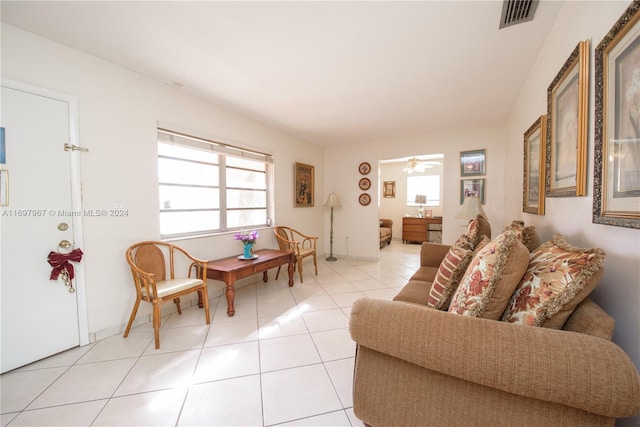 living room featuring ceiling fan and light tile patterned floors