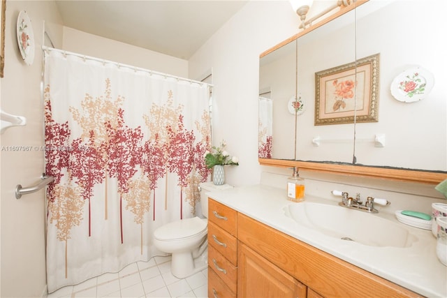 bathroom featuring tile patterned flooring, vanity, and toilet