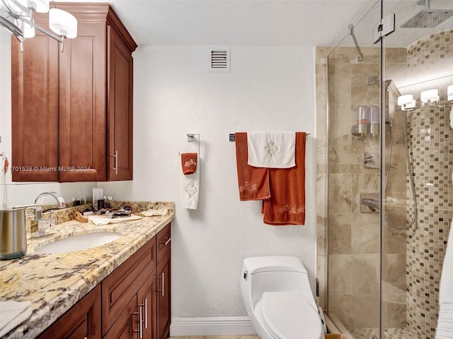 bathroom featuring vanity, toilet, and a shower with shower door