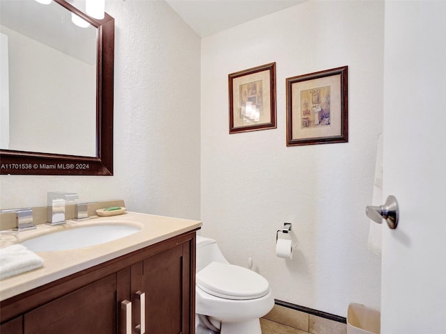 bathroom with tile patterned floors, vanity, and toilet