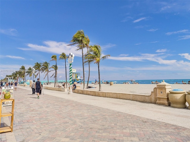 surrounding community with a view of the beach and a water view