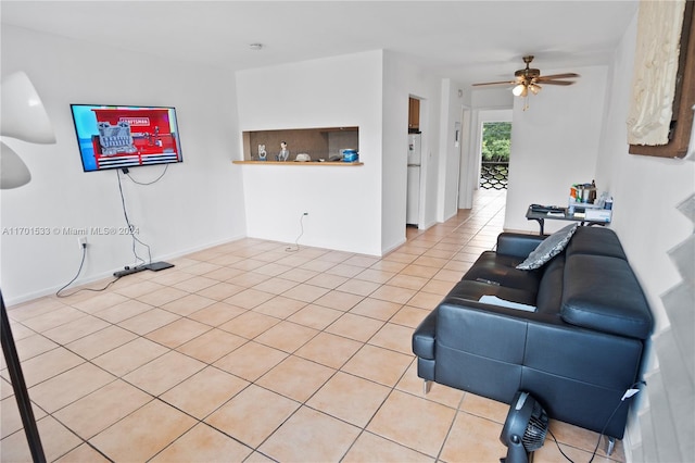 tiled living room featuring ceiling fan