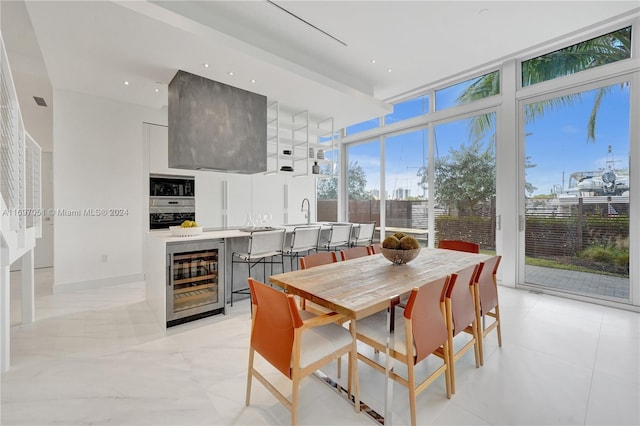 dining area with wine cooler and expansive windows