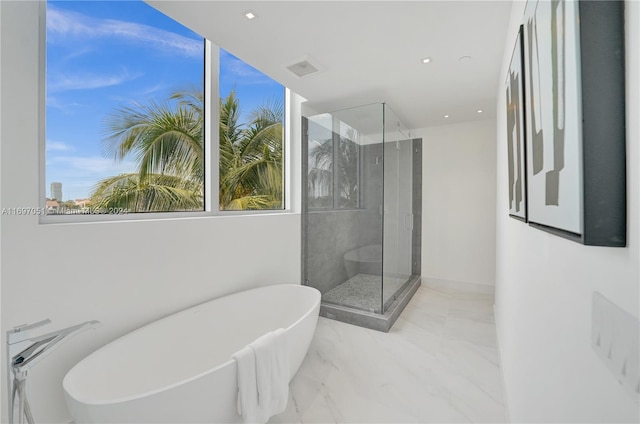 bathroom with separate shower and tub