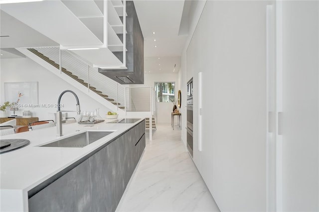 kitchen featuring stainless steel oven, black electric cooktop, and sink